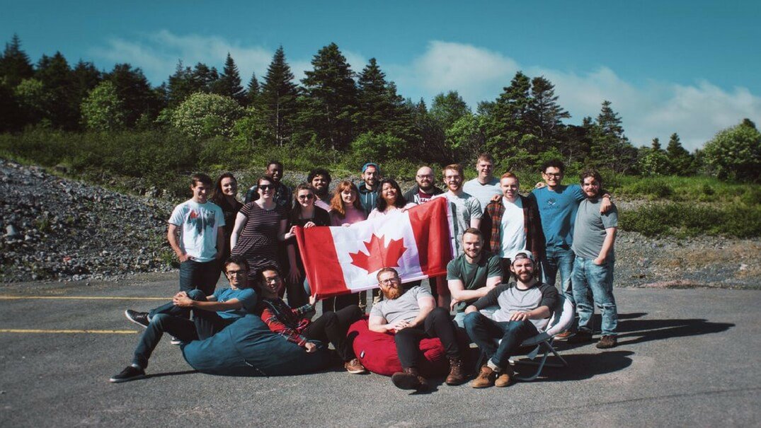 The HeyOrca team holding a Canadian flag together